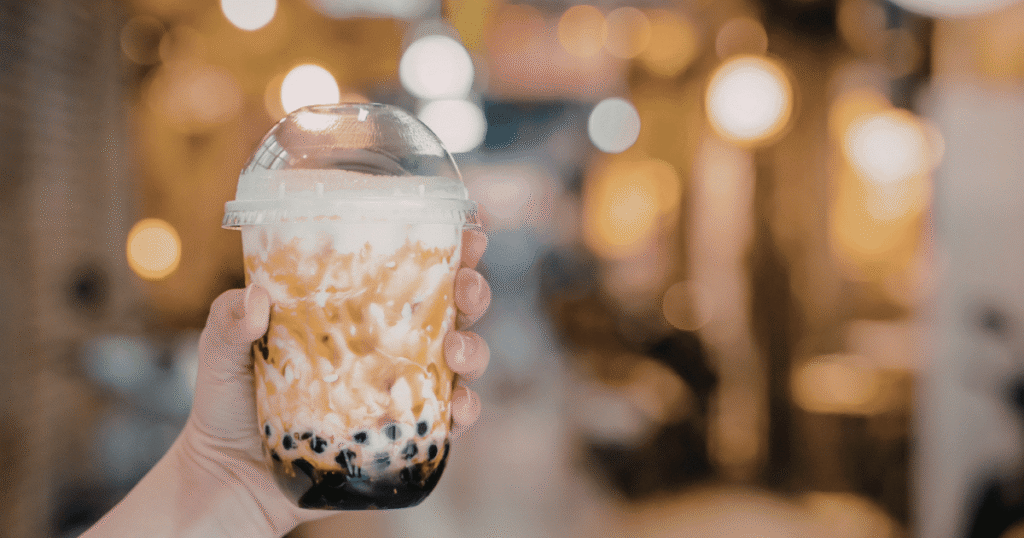 bubble milk tea in hand at night market