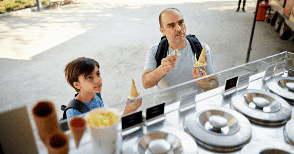 father and son buying at an ice cream truck